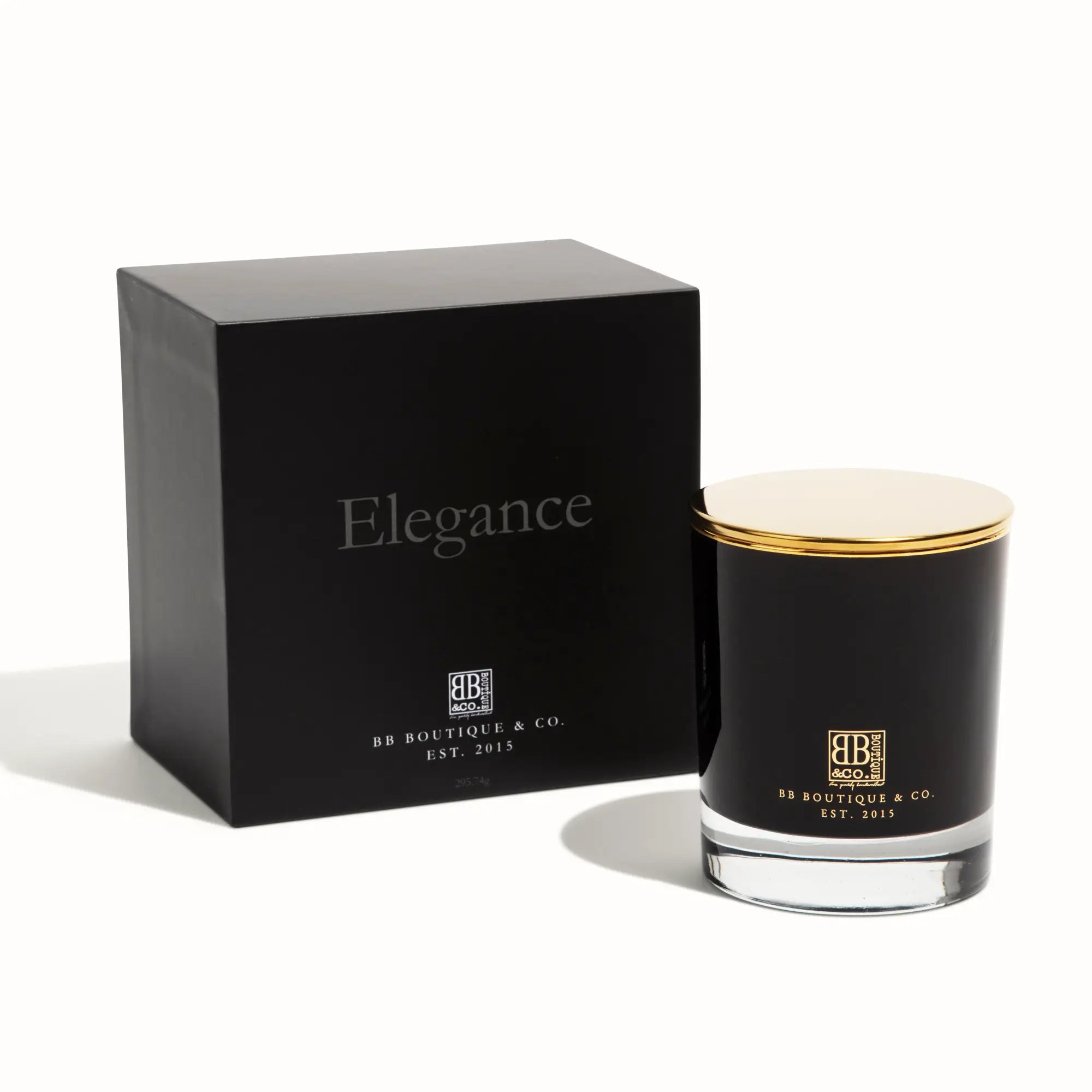 BB Boutique & Co. product image of a luxury black Elegance candle box with silver text and a matching black glass candle featuring a gold lid and clear base, both displaying gold branding on a white studio background