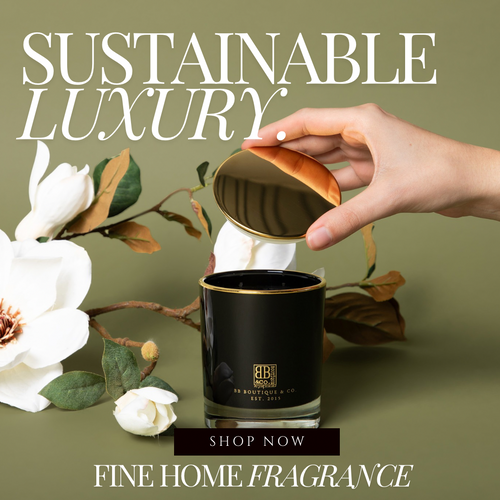 Hand removing the lid of a luxury candle with a green background and a white flower.