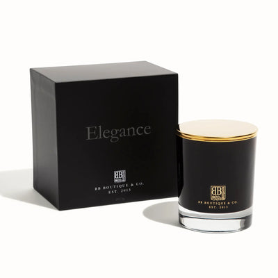 BB Boutique & Co. product image of a luxury black Elegance candle box with silver text and a matching black glass candle featuring a gold lid and clear base, both displaying gold branding on a white studio background